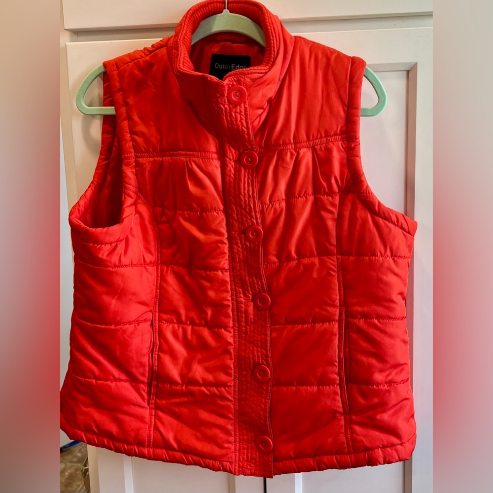 Women’s extra large quilted vest made by Outer Edge.  Color is orange.